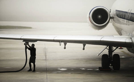 Aircraft being refueled on a tarmac